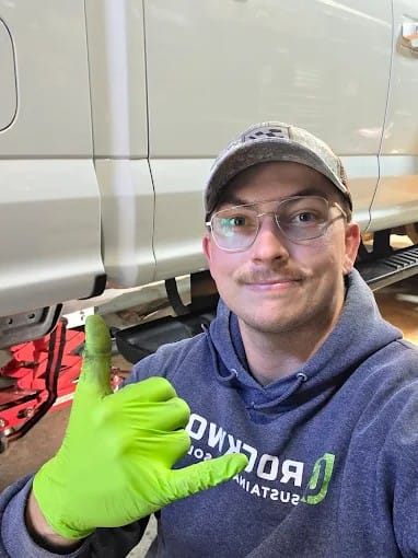 WrenchPro owner and lead technician, Mikal, standing in front of a mobile automotive repair van.